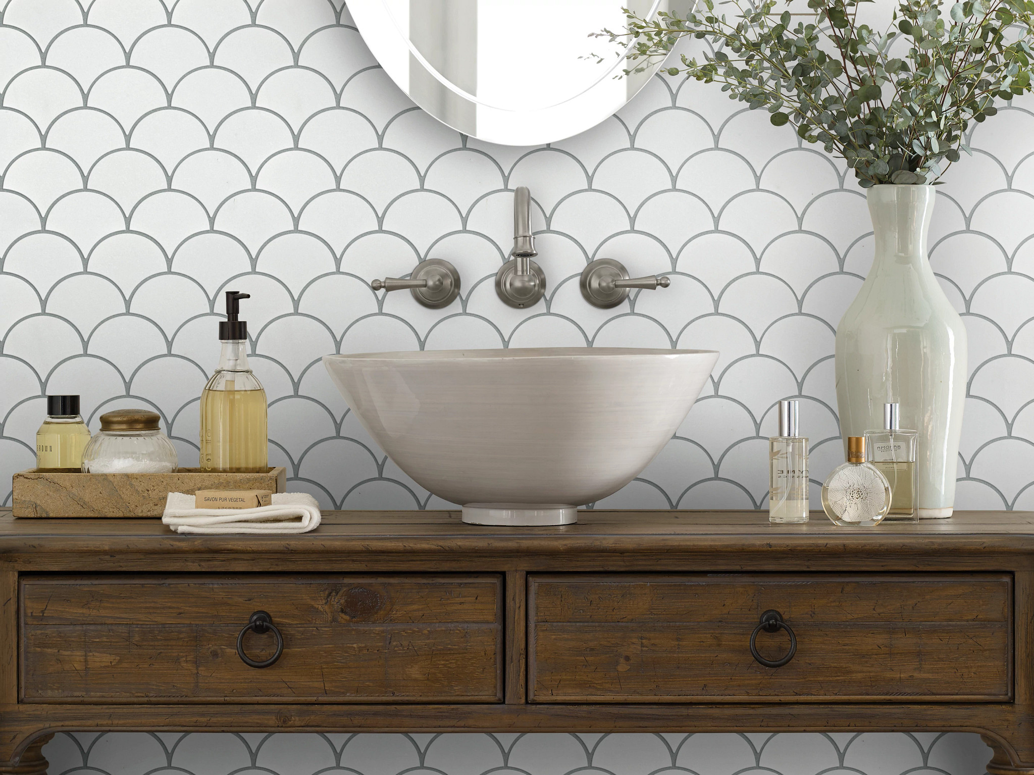 A natural stone backsplash behind a bathroom vanity at 